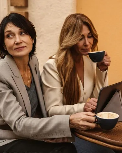 Two friends chatting over coffee